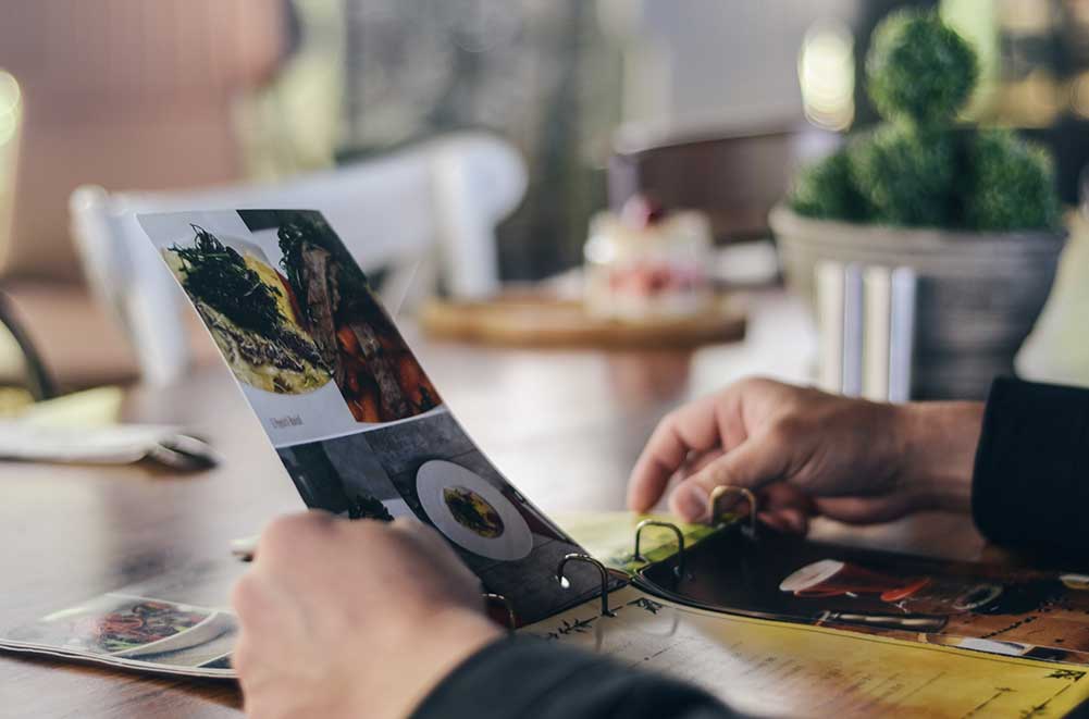 Person holding a paper menu